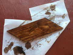 Staining a piece of wood.