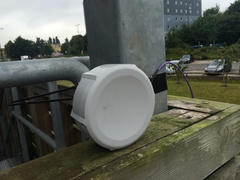 MikroTik SXT device attached to steel structure.