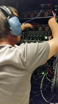Man installing equipment in a server rack.